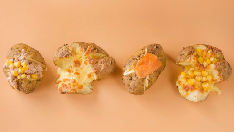 display of air fryer jacket potatoes on a tangerine background