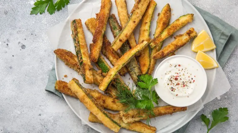 air fryer crispy courgette fries on a white plate