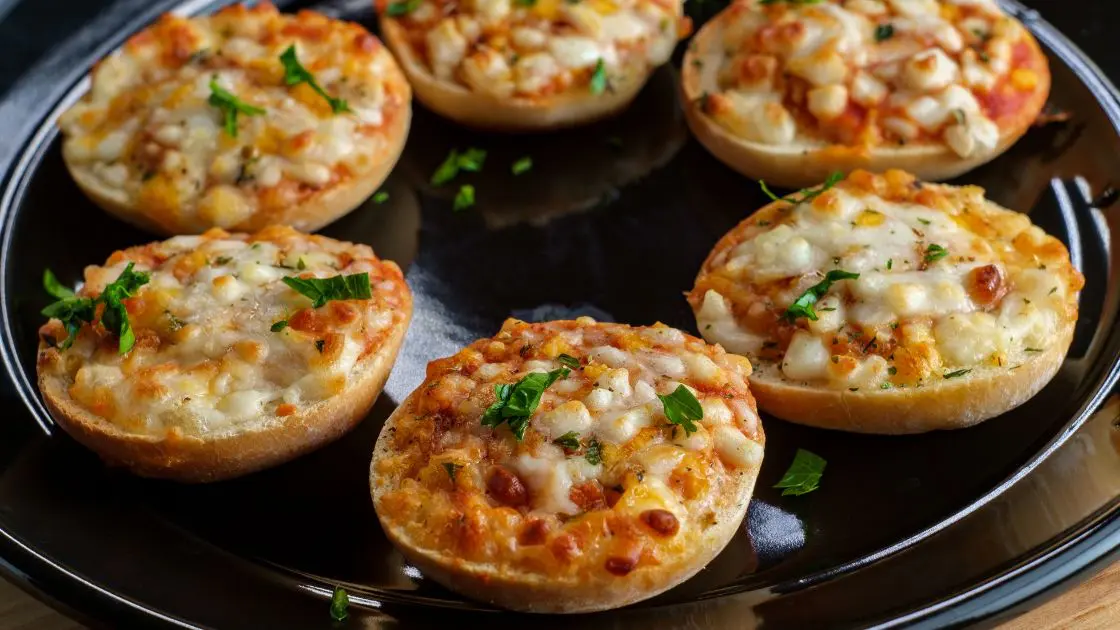 Starters And Snacks Air Fryer Pizza Bagel Bites On A Black Plate